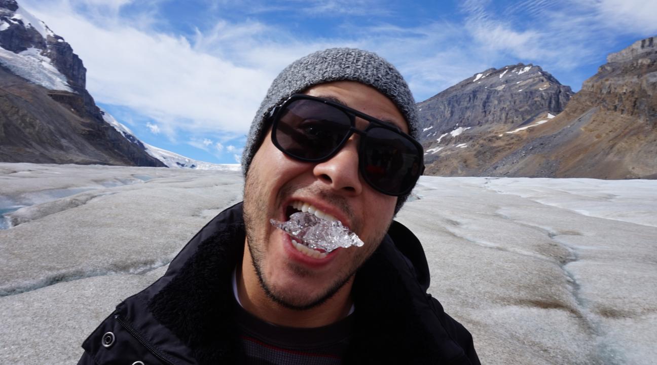 Student tasting clear glacial ice