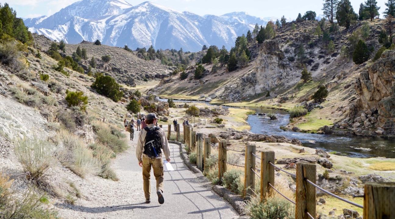 Student walking down a trail