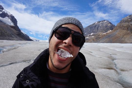 Student tasting clear glacial ice
