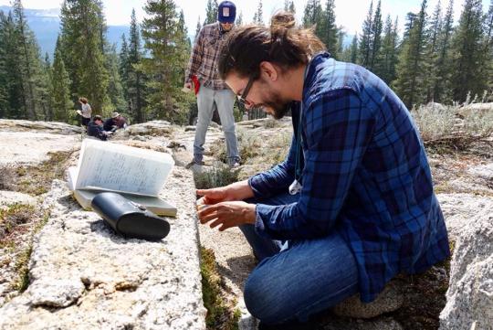Student measuring an outcrop in the field