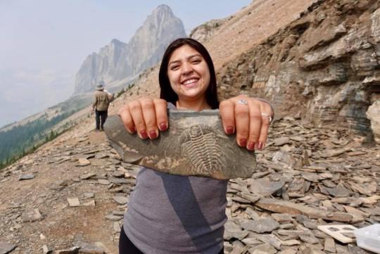 Student holding trilobite