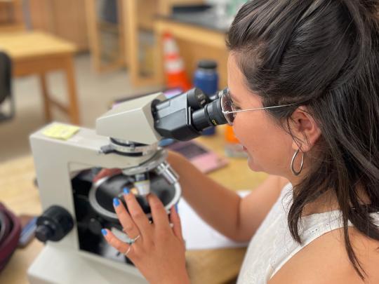 Student looking in microscope