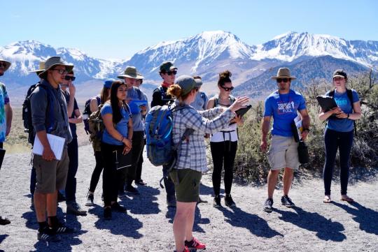 Faculty pointing to the mountains