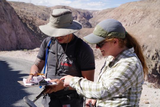 Student and faculty examining hand samples